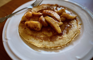 Fluffy Overnight Sourdough Pancakes Topped with baked cinnamon apples