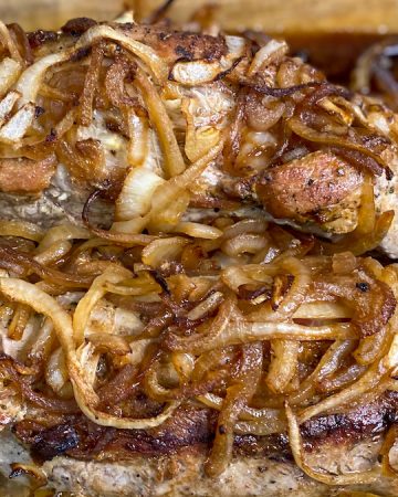 two roasted pork tenderloins topped with cartelized onions