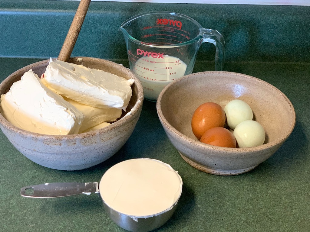 Classic New York Cheesecake ingredients on the counter coming to room temperature