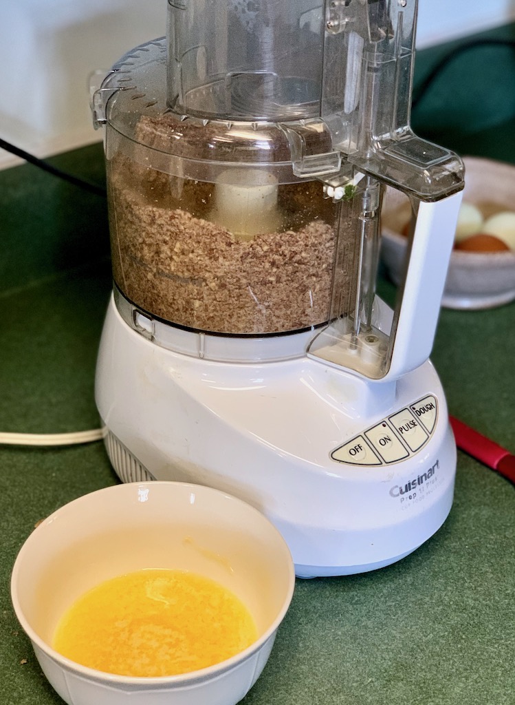 Adding butter to ground pecans for cheesecake crust