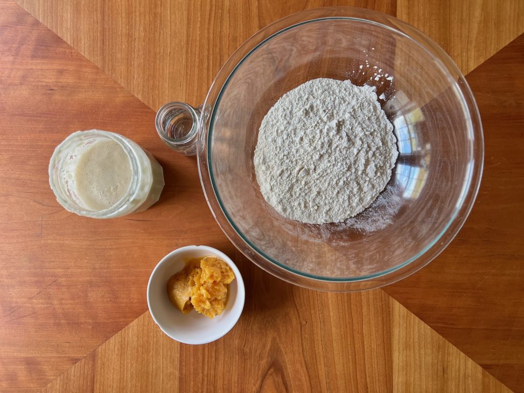 All-purpose flour, active sourdough starter, orange juice concentrate, and water for an overnight sourdough ferment