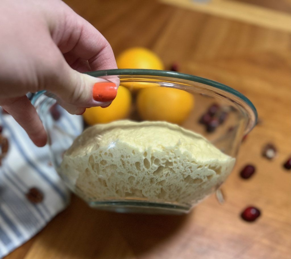 Loosened sourdough dough with visible fermentation bubbles after a long room-temperature ferment.