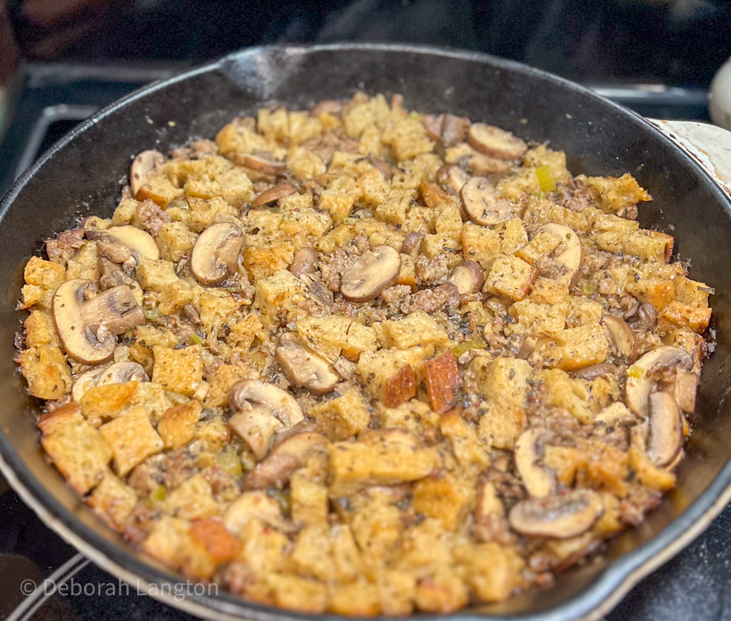 Baked and steaming sage sourdough stuffing in a cast iron pan
