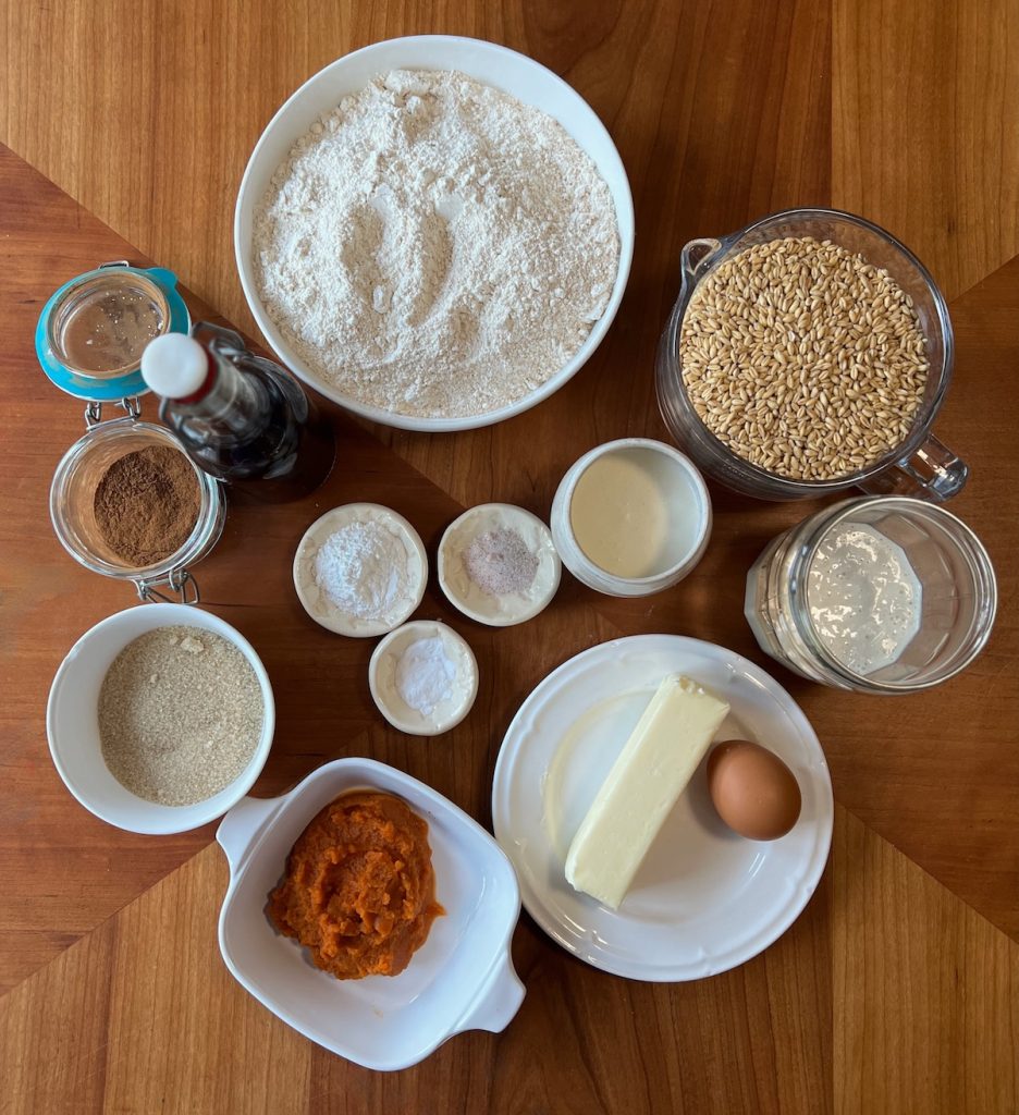 Ingredients for fresh-milled pumpkin sourdough discard scones arranged on a wooden table.