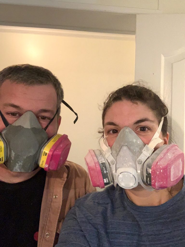 Deborah and Trey wearing respirators during their home renovation