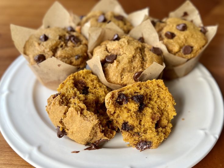 Fresh-milled pumpkin chocolate chip muffins with tall golden tops and a soft, moist crumb