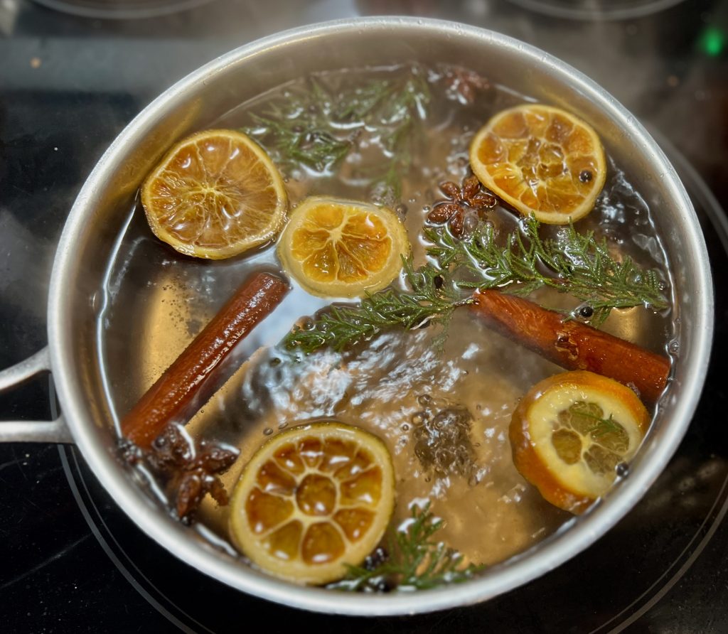 Orange juniper cinnamon and star anise simmering on the stove