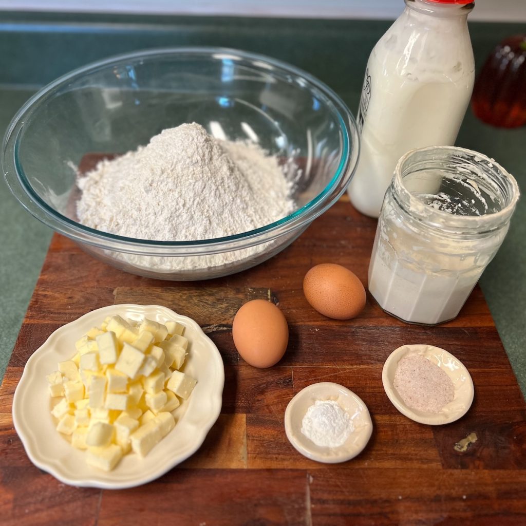 Ingredients for homemade sourdough discard dumplings including flour, butter, eggs, discard, and buttermilk