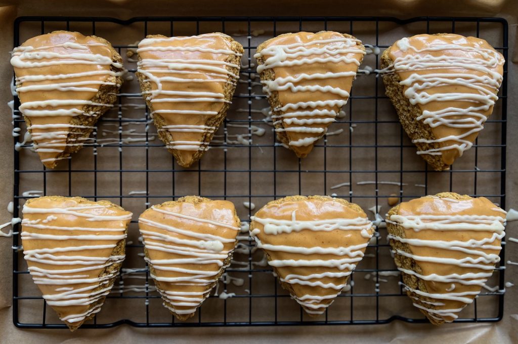 Pumpkin-maple glazed sourdough scones finished with a thin white vanilla drizzle.