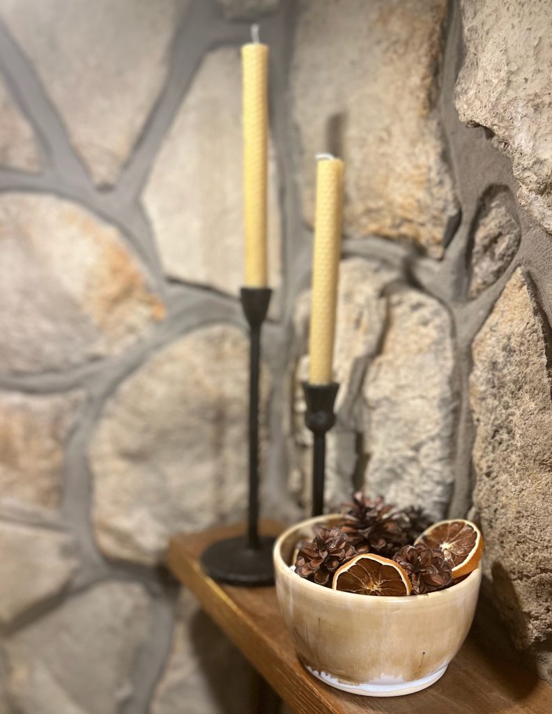 Rolled Beeswax candles and pinecones arranged as simple natural fall decorations.
