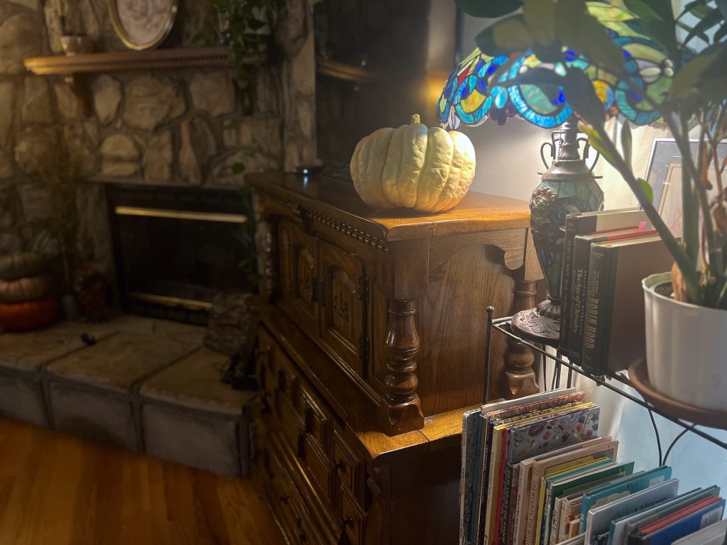 A glowing lamp illuminates a cozy corner of the living room