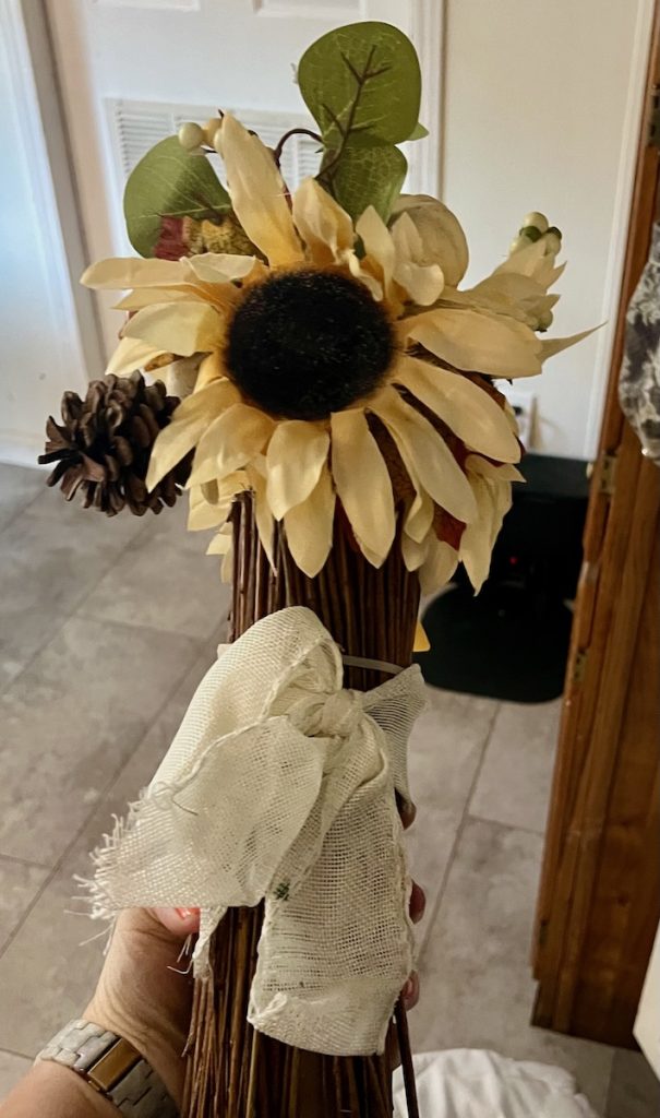 an old fall sunflower decoration that will be used for repurposing material