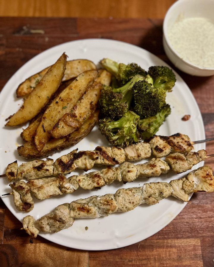 Grilled chicken skewers with roasted potato wedges, broccoli, and ranch dip
